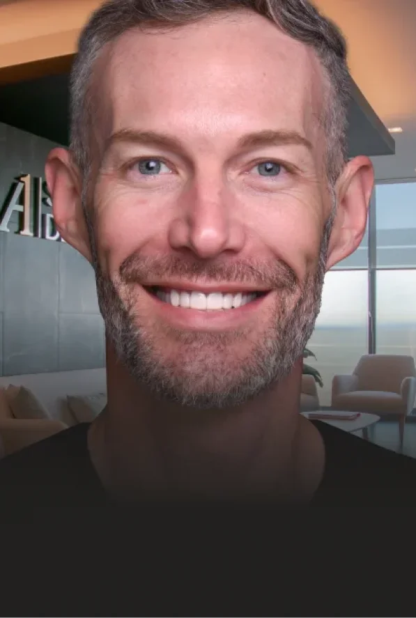 middle aged man smiling after getting a full mouth veeners treatment
