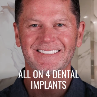 patient smiling after All on 4 dental implants treatment