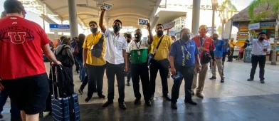 Group of travelers being guided inside Cancun International Airport