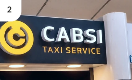 CABSI Taxi Service sign inside airport transportation area.