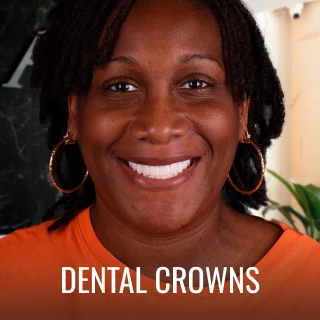 happy patient showing dental crowns results from A1 Smile Design