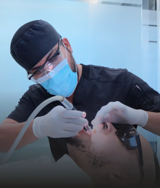 Dr Daniel Leyva posing with a astonished patient who got dental work done