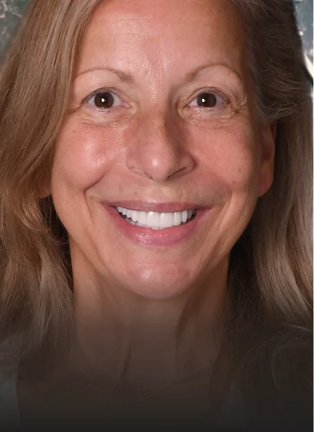 Mature woman with rejuvenated smile after cosmetic dentistry and dental restoration at A1 Smile Design.