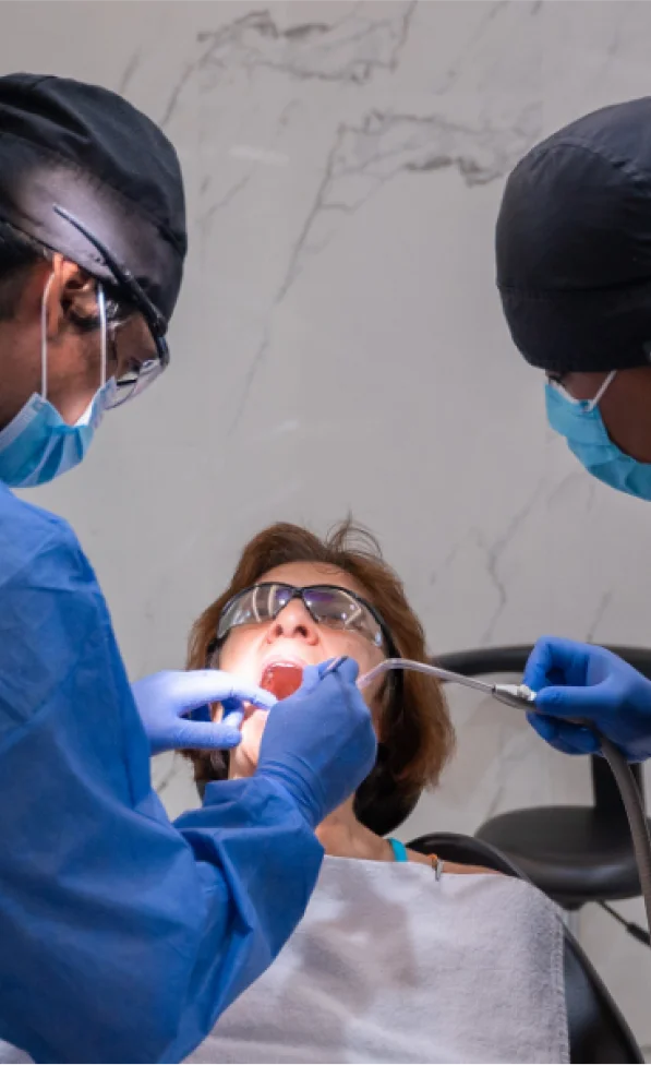dental specialists performing dental work on lady
